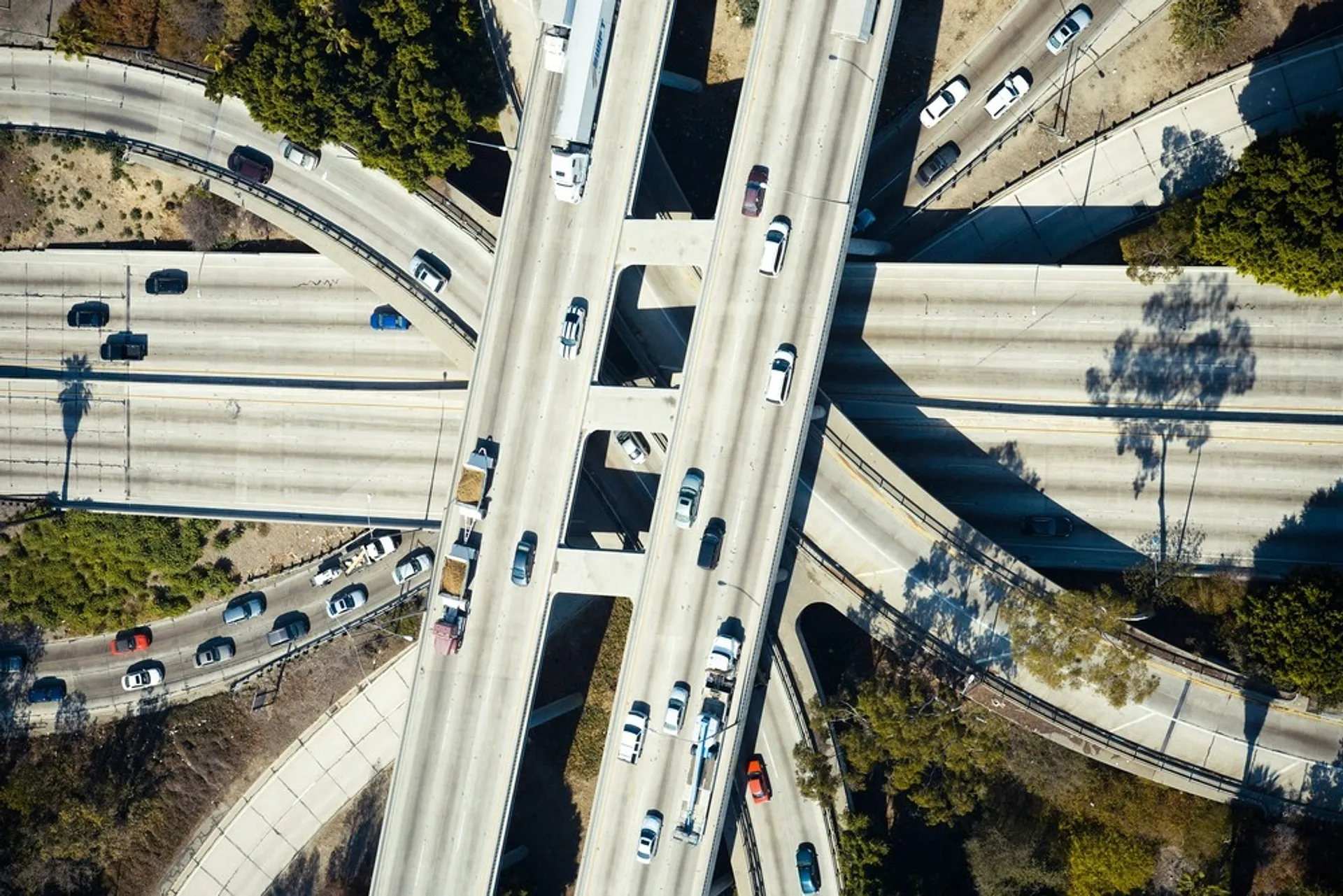 An intricate web of highways intersect at a dense Los Angeles freeway interchange.