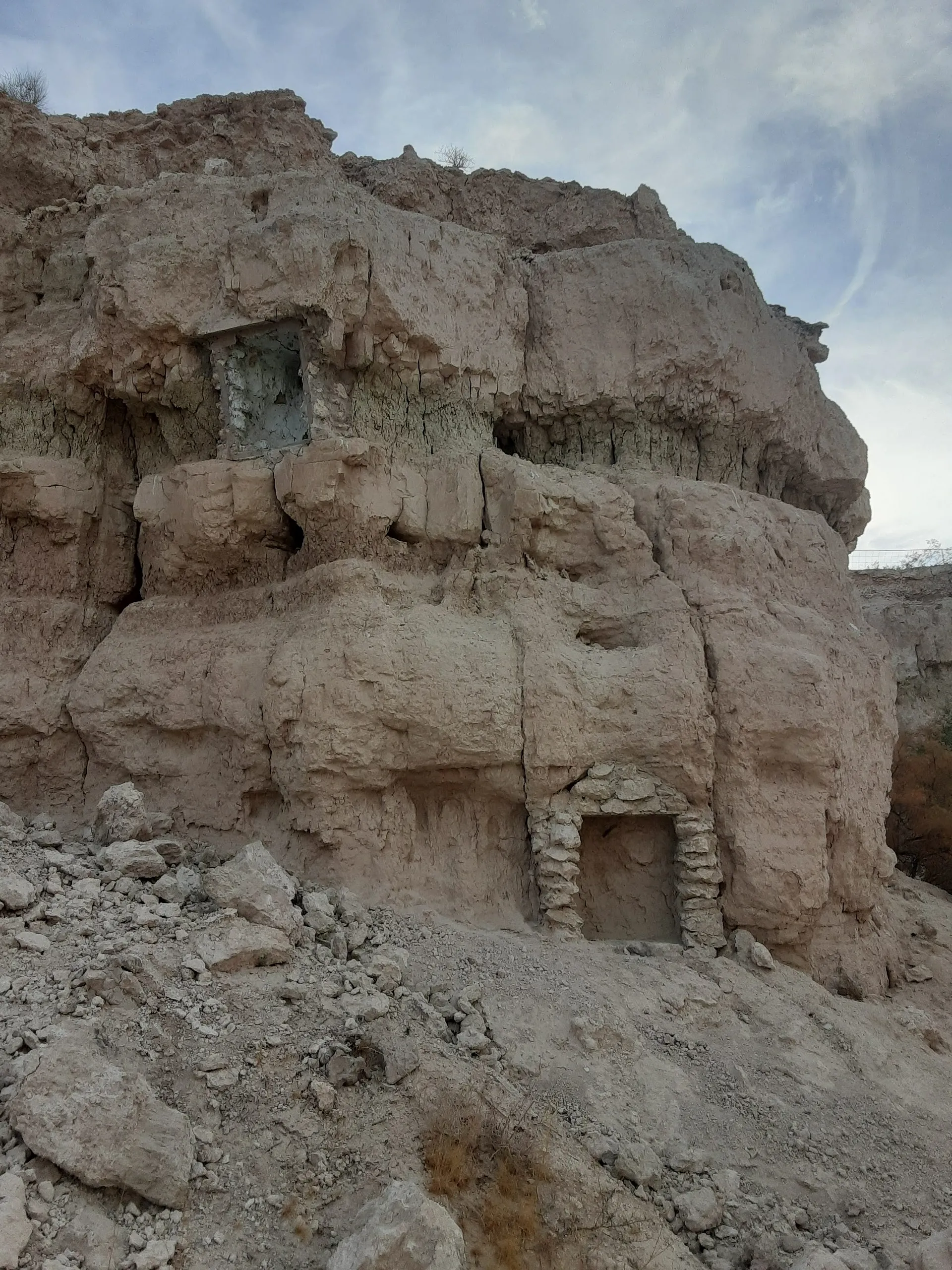 Rocky cliffside with decaying brick shrines