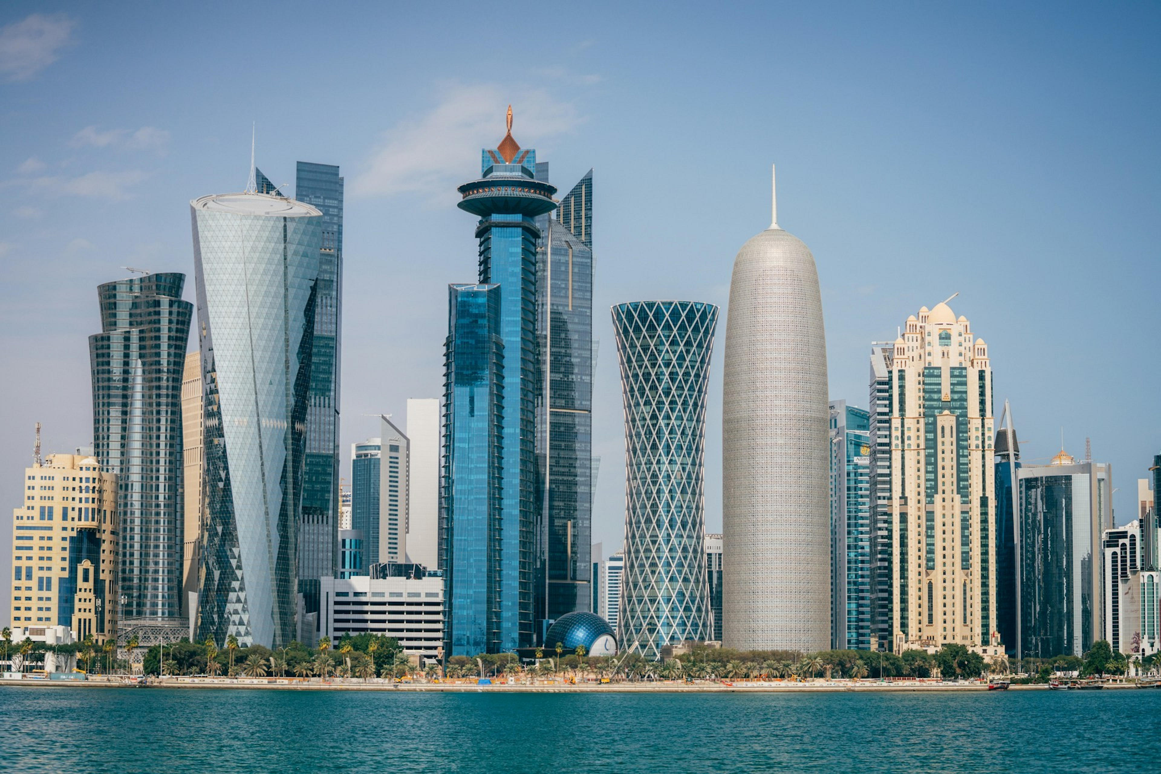 A stunning skyline of modern skyscrapers dominates the waterfront in Doha, Qatar.