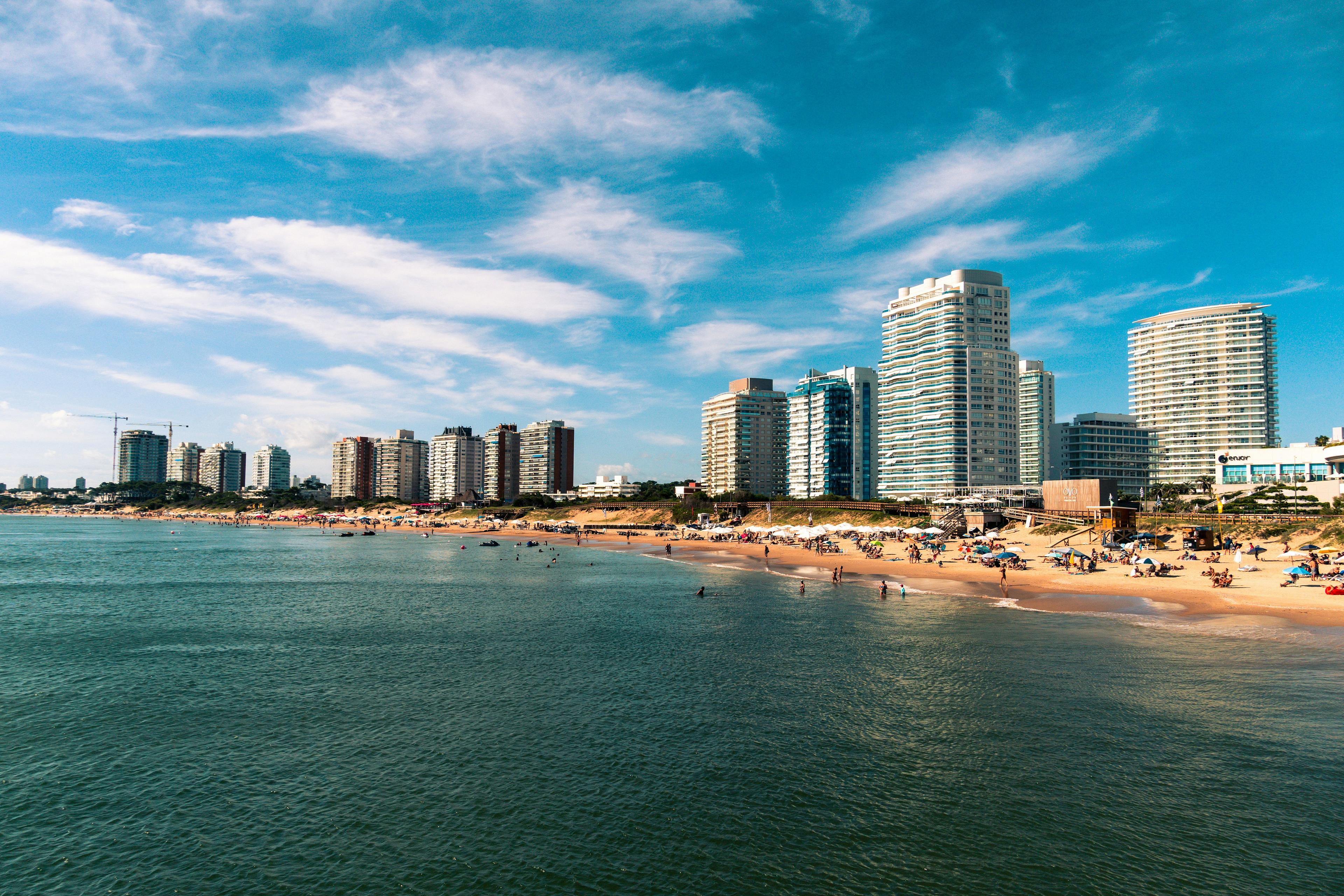 A bustling beach bordered by modern high-rise buildings in Punta del Este, Uruguay.