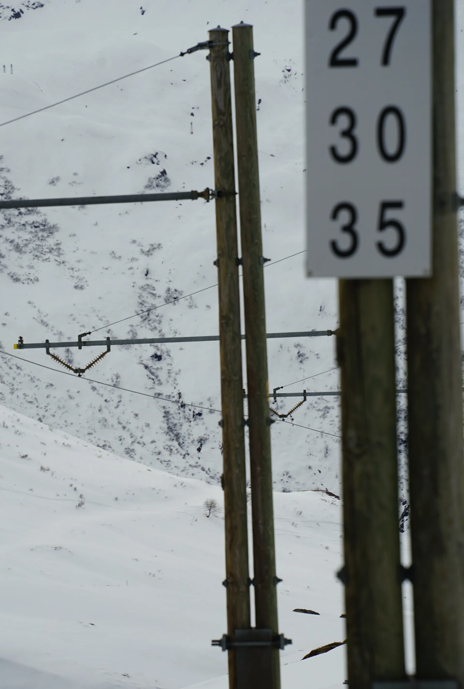 Snowy mountains and power lines create an alpine setting in the Swiss Alps.