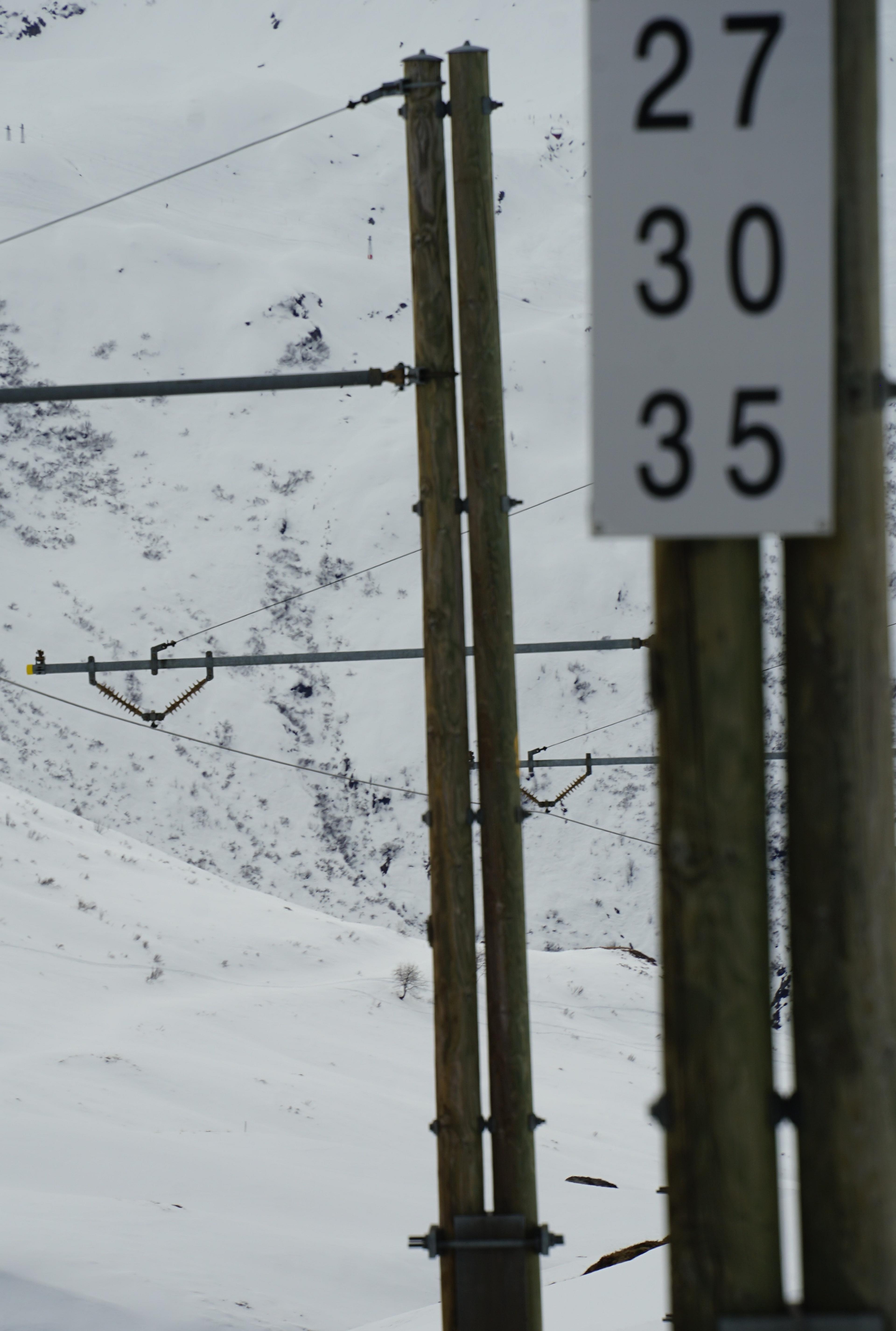 Snowy mountains and power lines create an alpine setting in the Swiss Alps.