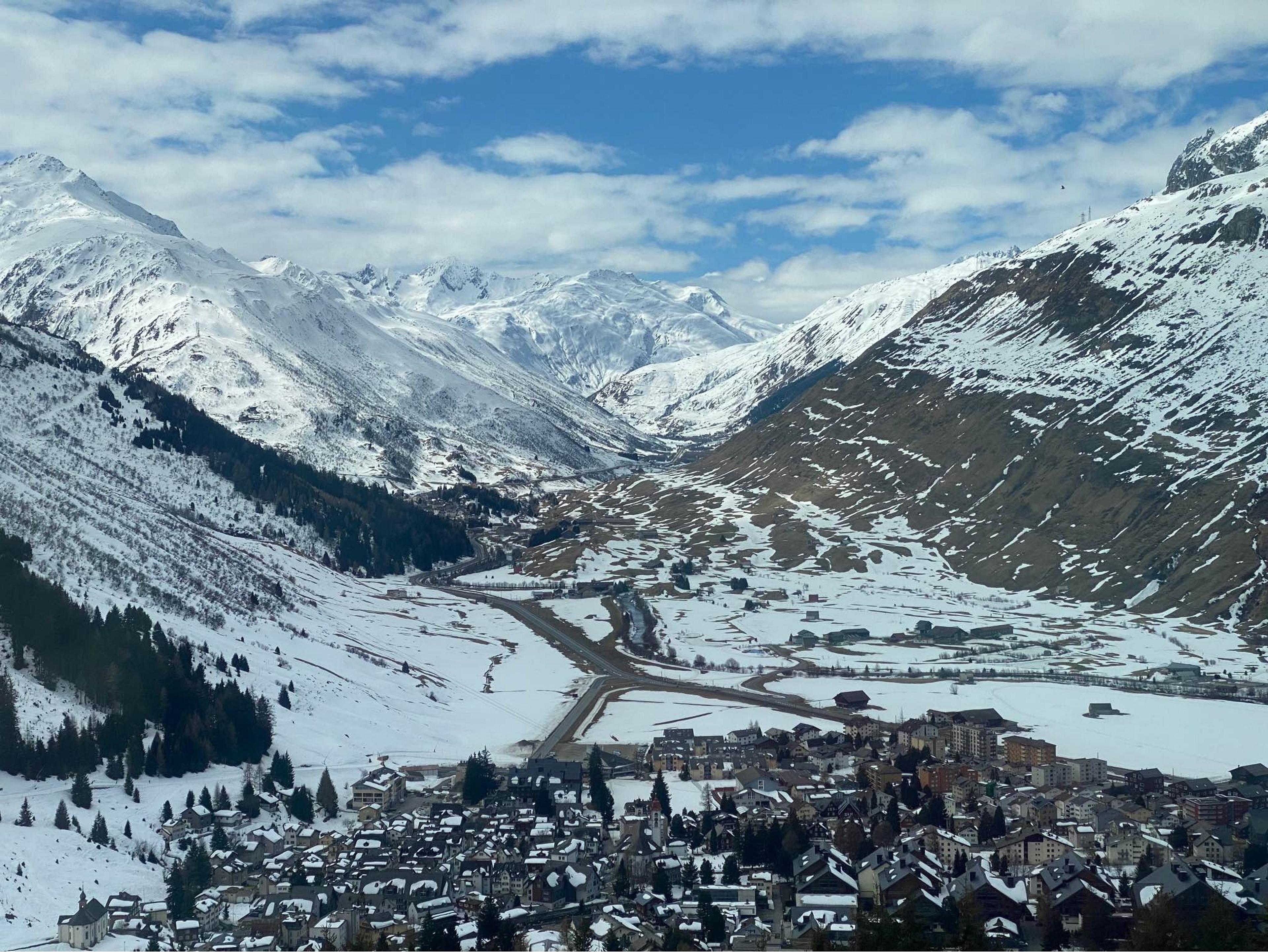 A picturesque view of a snow-covered mountain village in Liddes, Switzerland, nestled among the Alps.