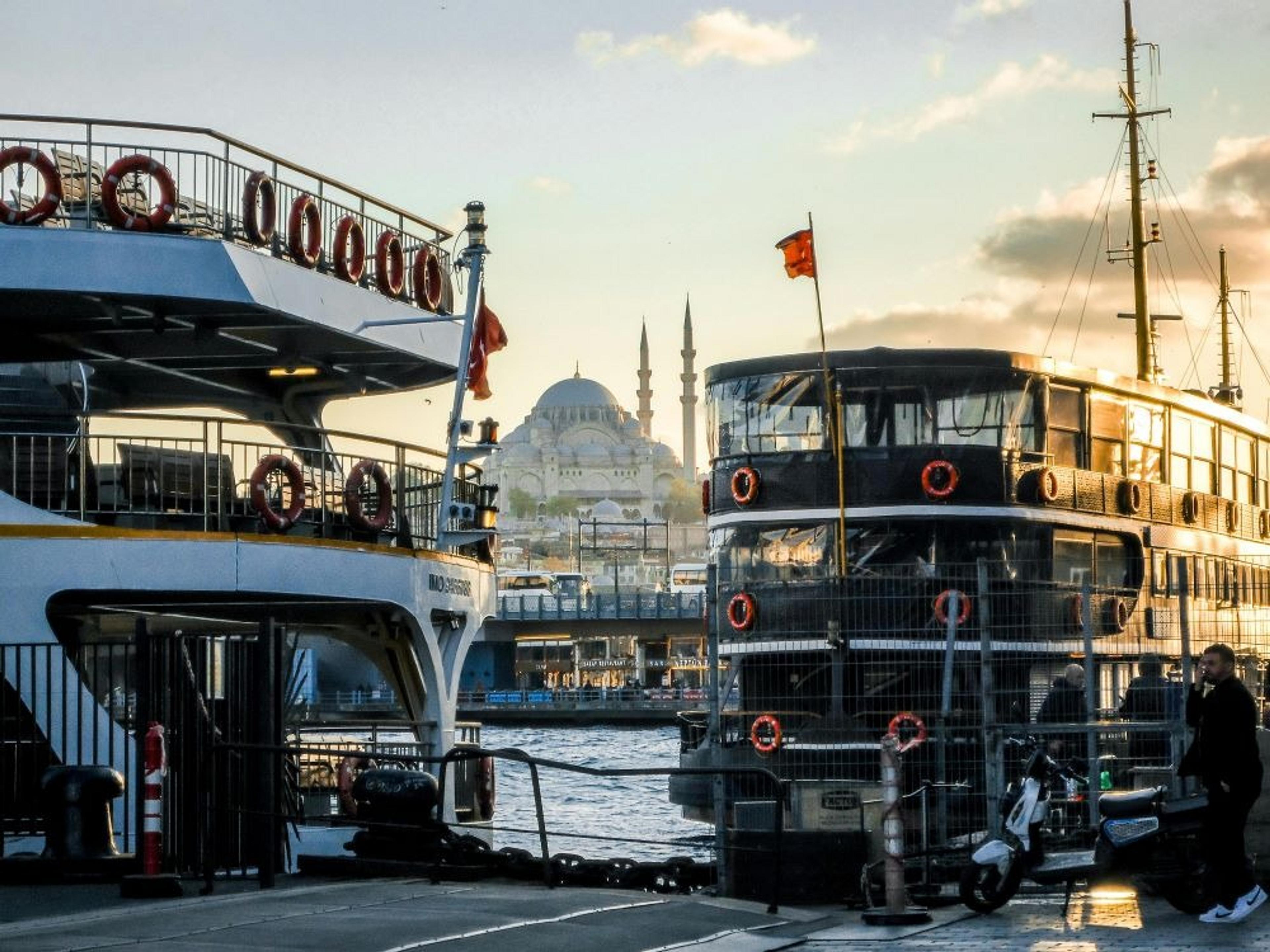 Ferries on the dock in Istanbul with mosque in the background