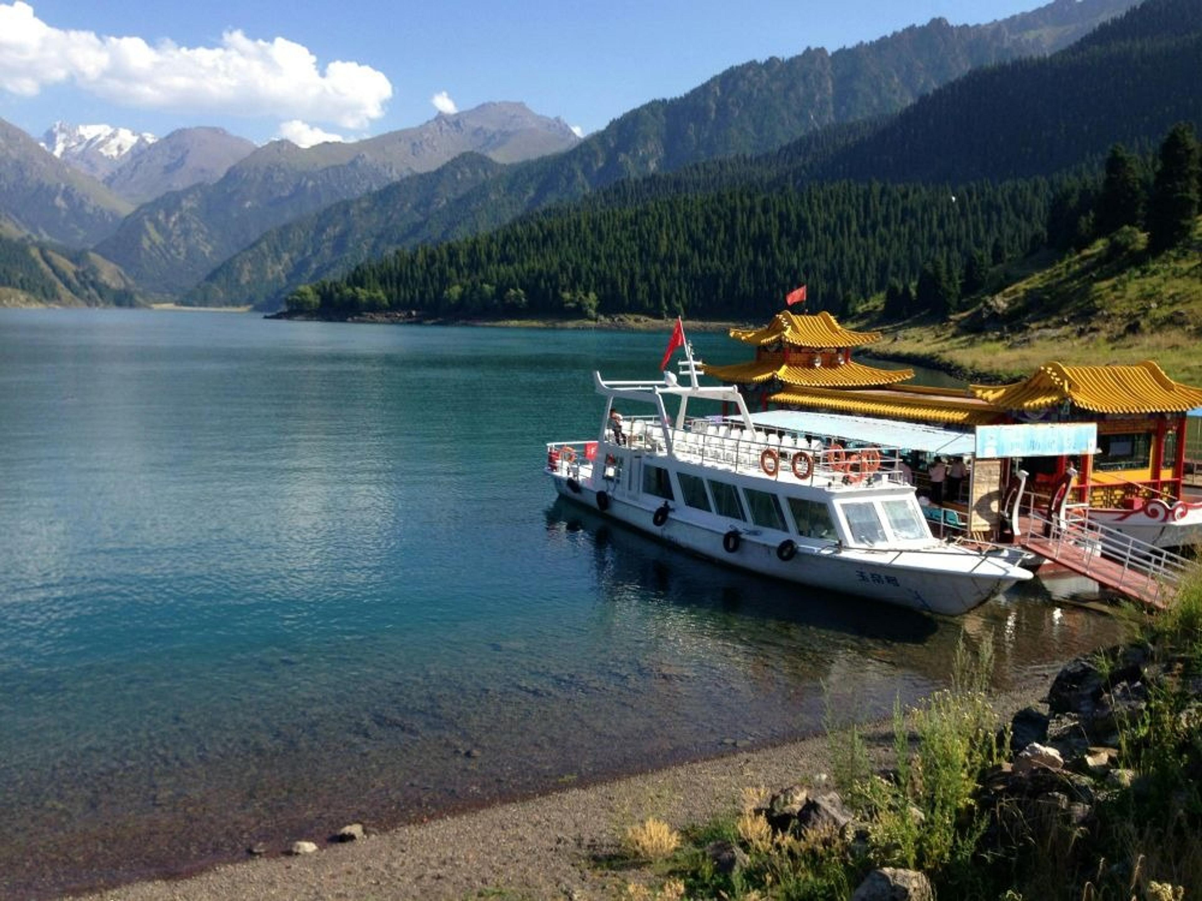 A boat is docked at the picturesque Heaven Lake in the Tianshan Mountains of Xinjiang, China.