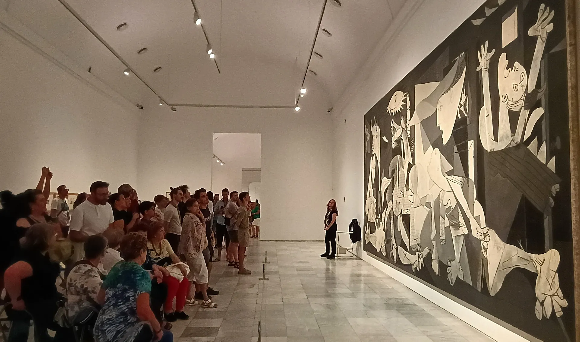 Visitors admiring Picasso's "Guernica" at the Museo Reina Sofía in Madrid.
