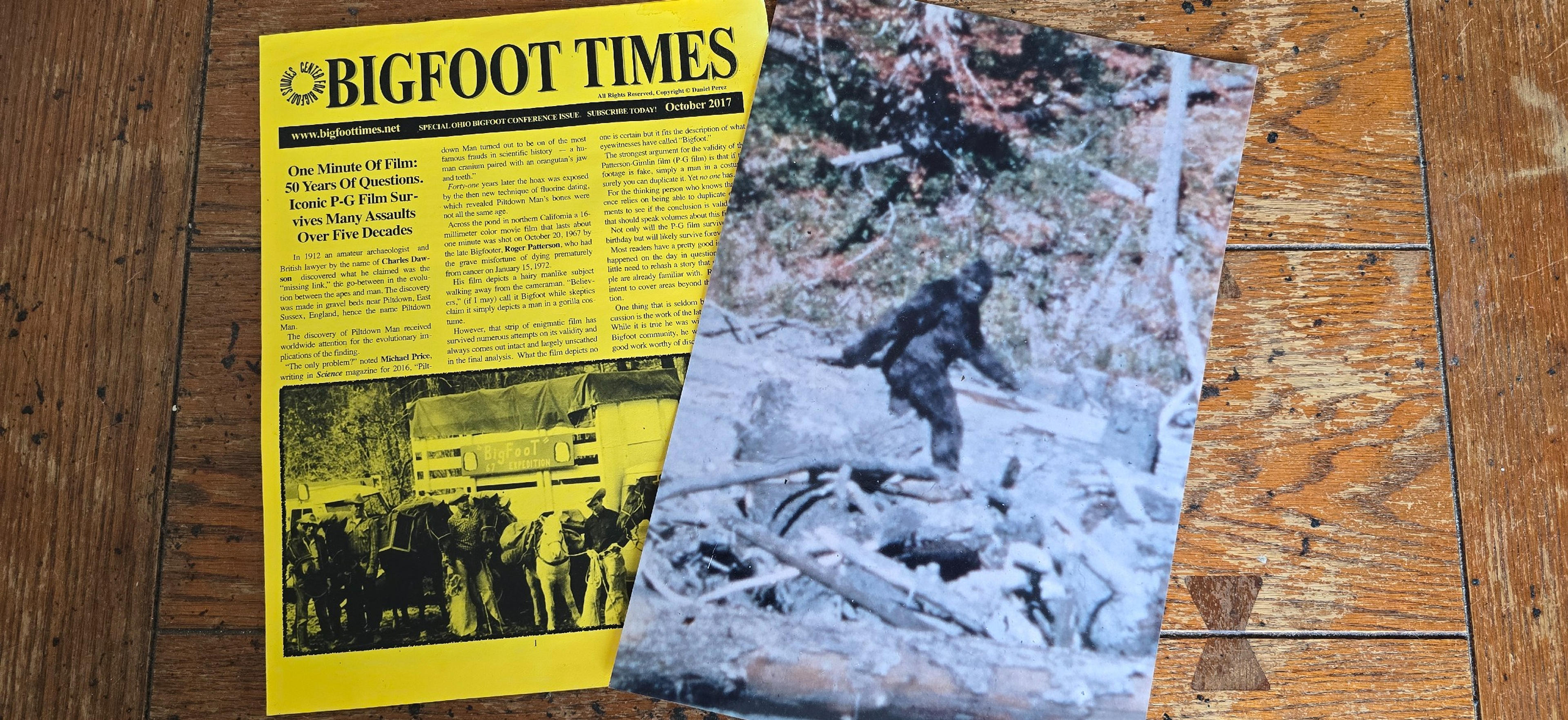 A yellow issue of "Bigfoot Times" from October 2017, alongside a photograph of the purported Bigfoot.