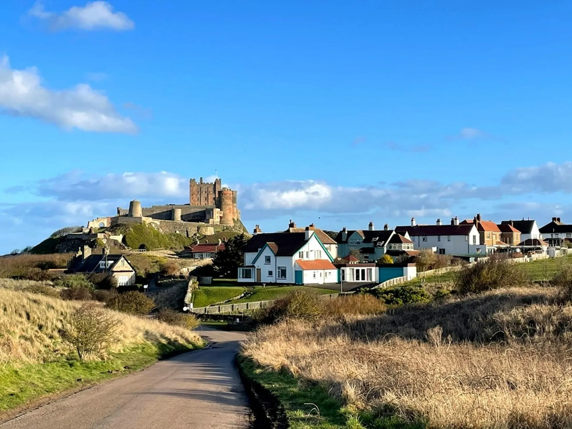 Town of Bamburgh with castle perched on the hill