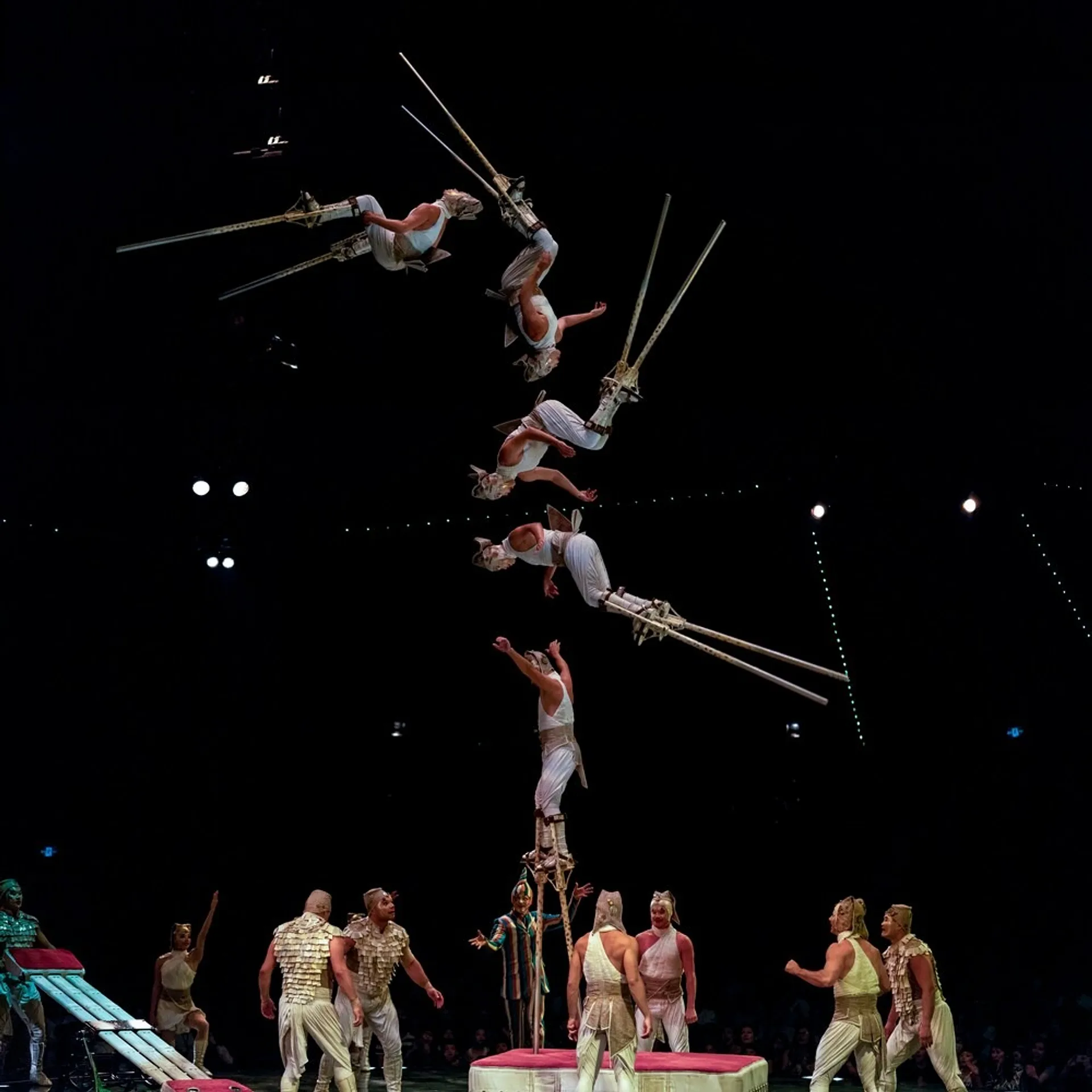 Acrobat hurling themself through the air at a cirque performance.