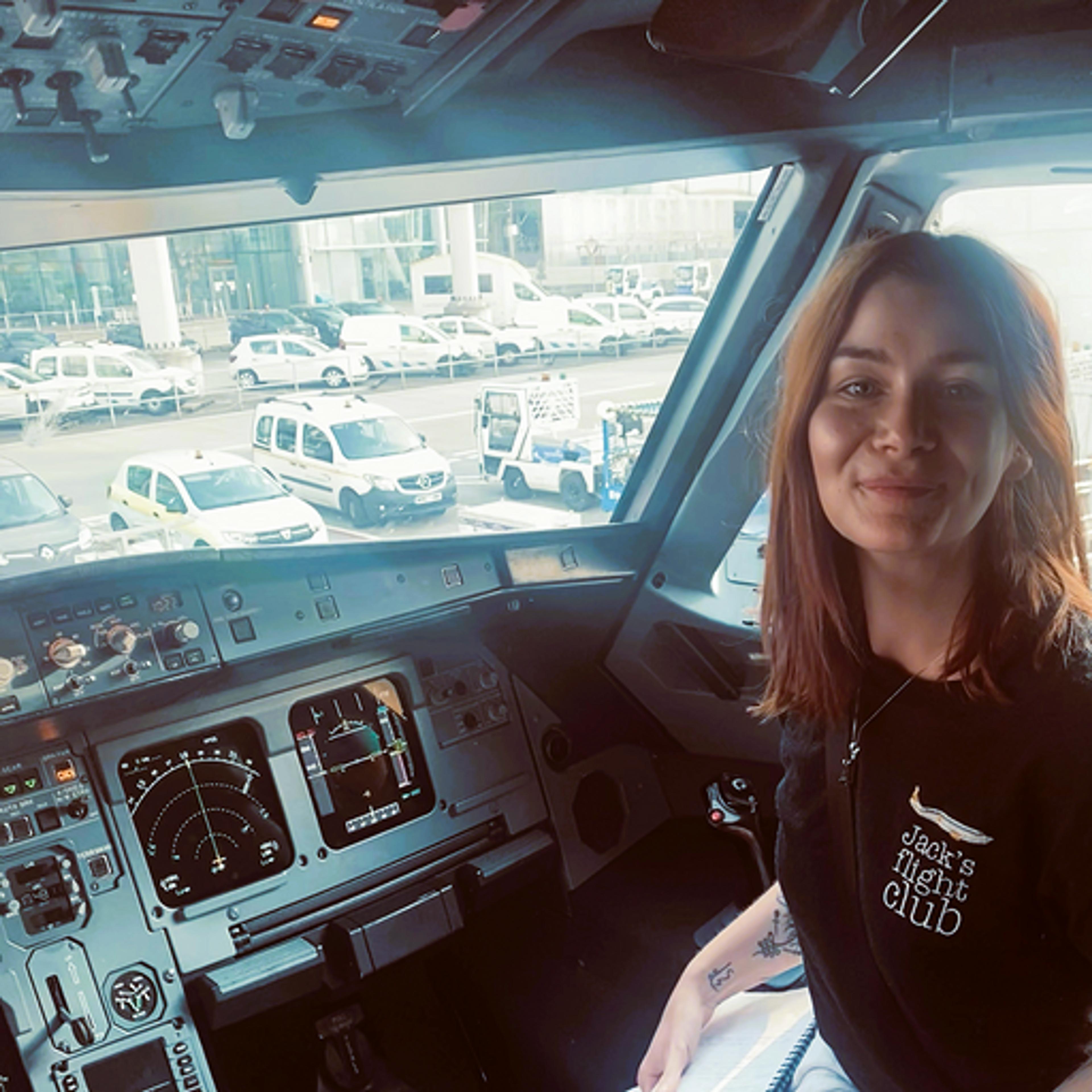 Author Kash sits in the cockpit of a plane