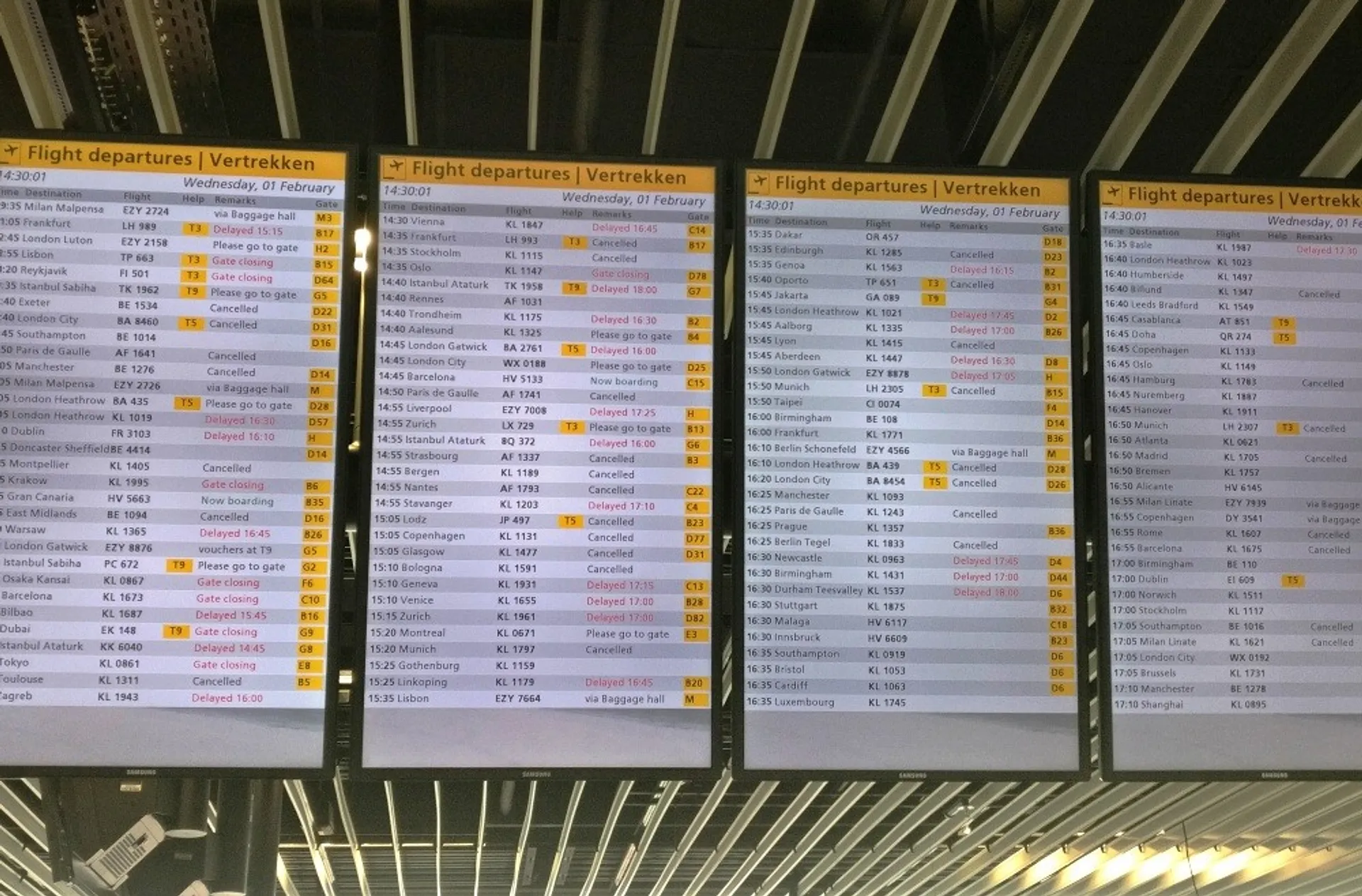 Departures boards showing several cancellations and delays