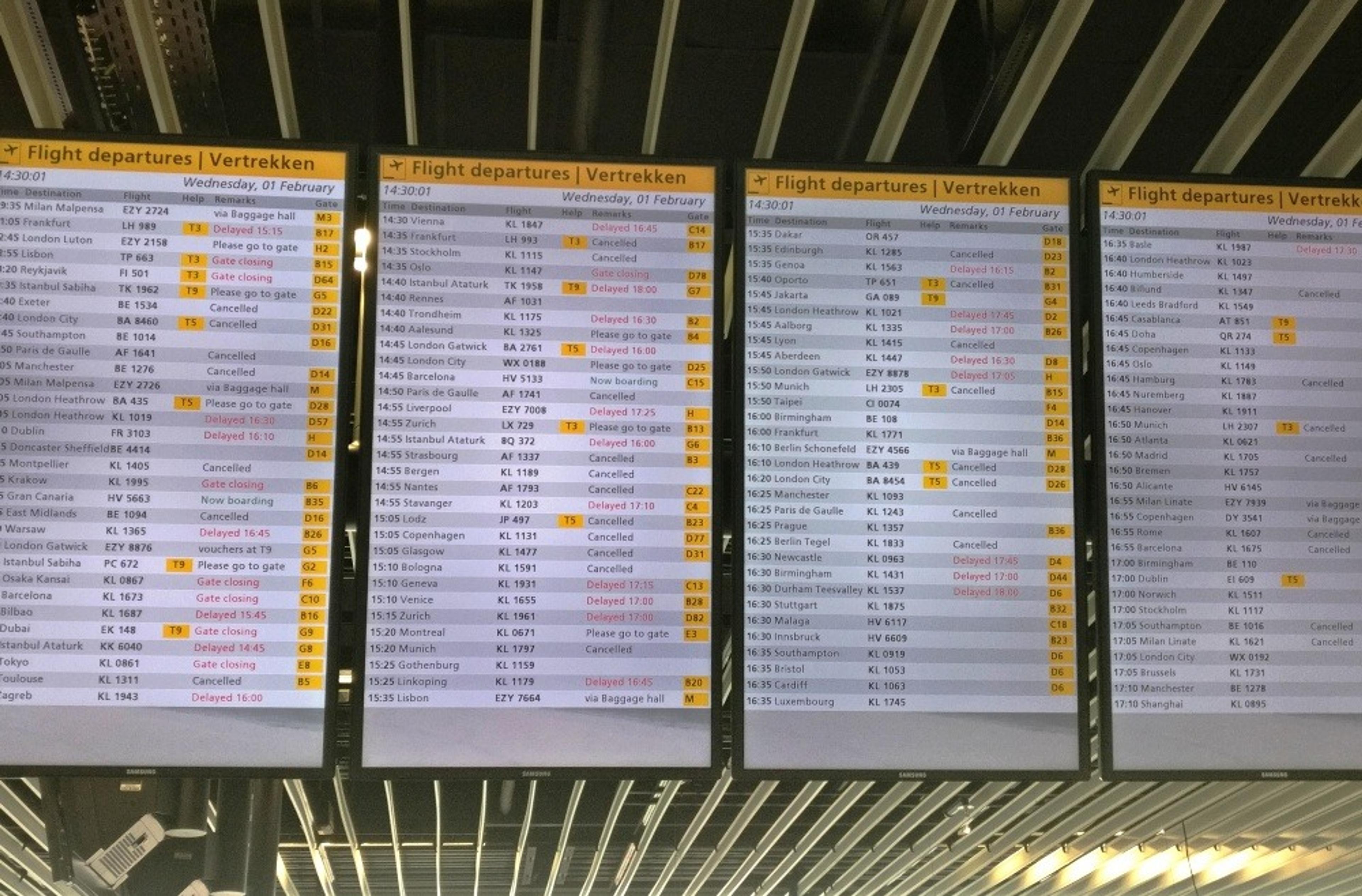 Departures boards showing several cancellations and delays