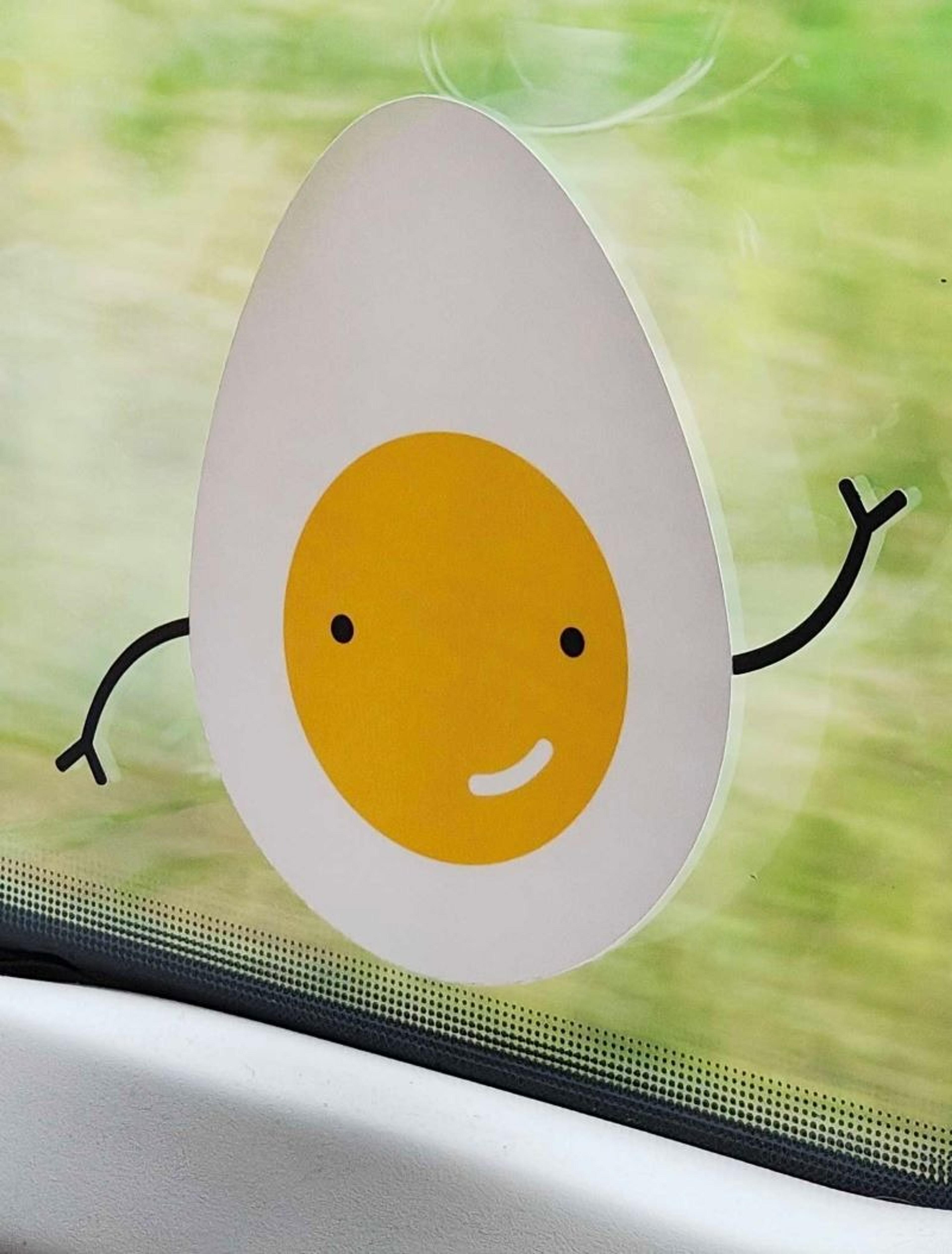 Cartoon egg sticker smiling and waving on the window of a Lithuanian train