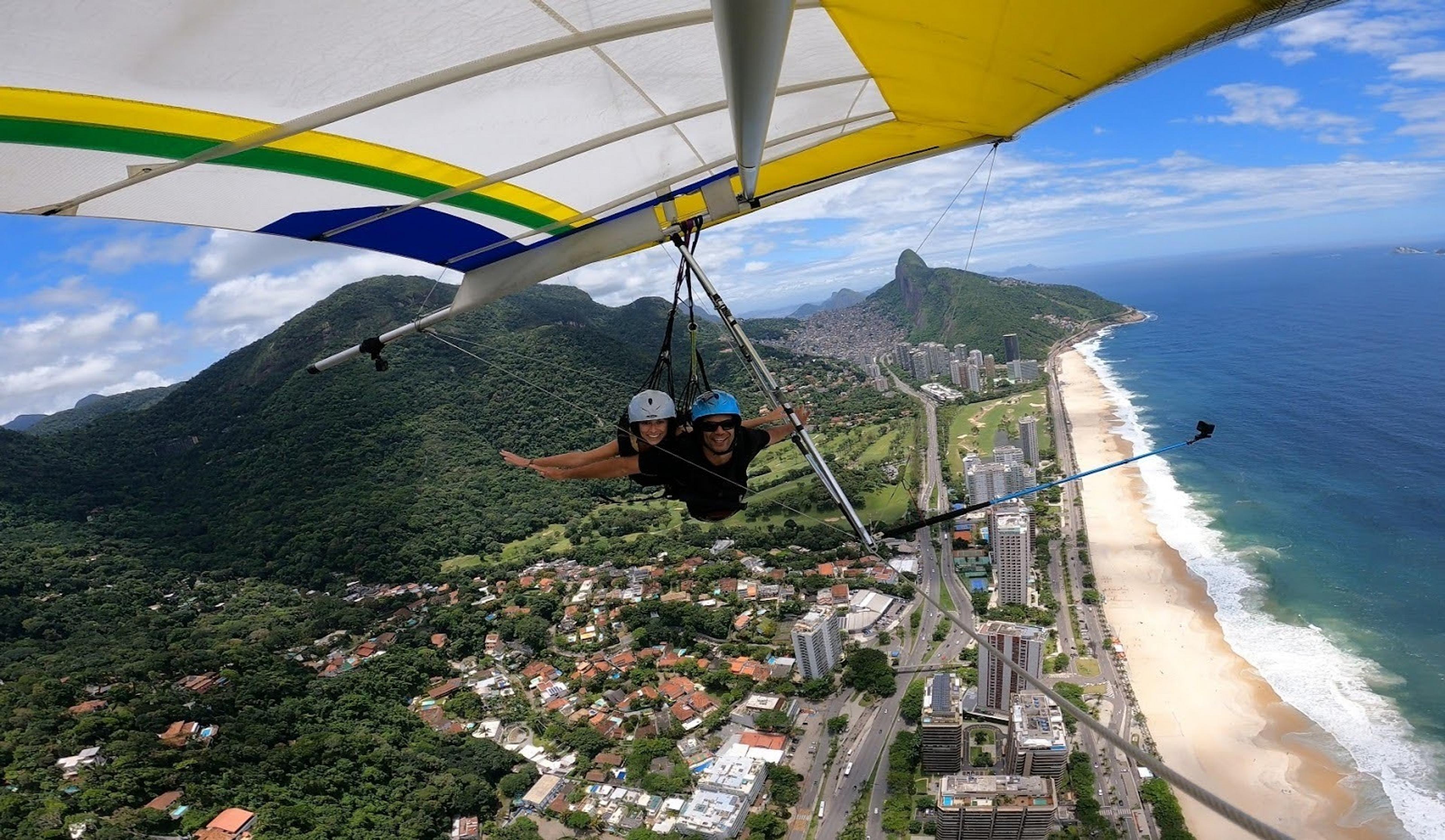 Paragliding above beach and city