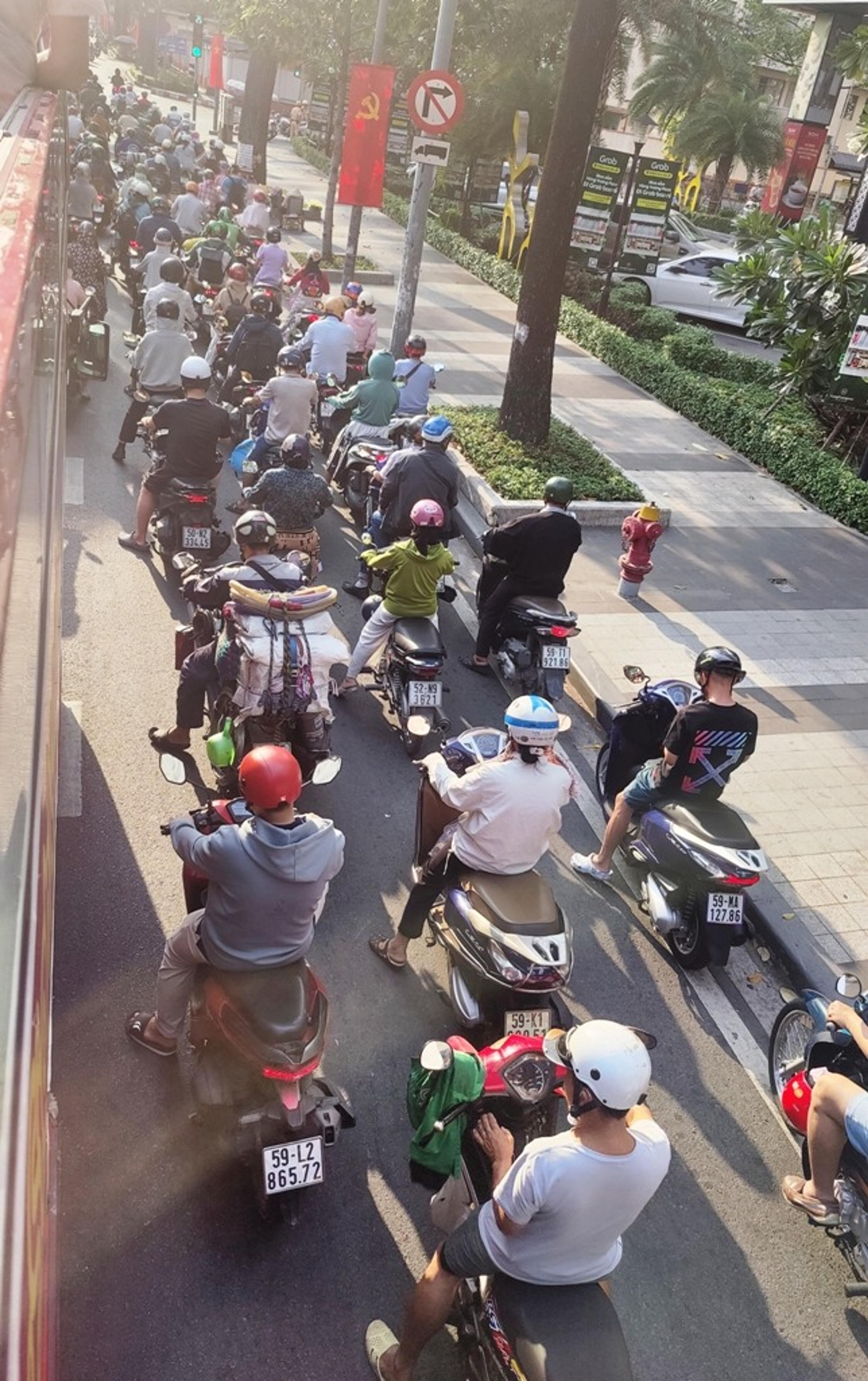 Scooters lined up at traffic lights