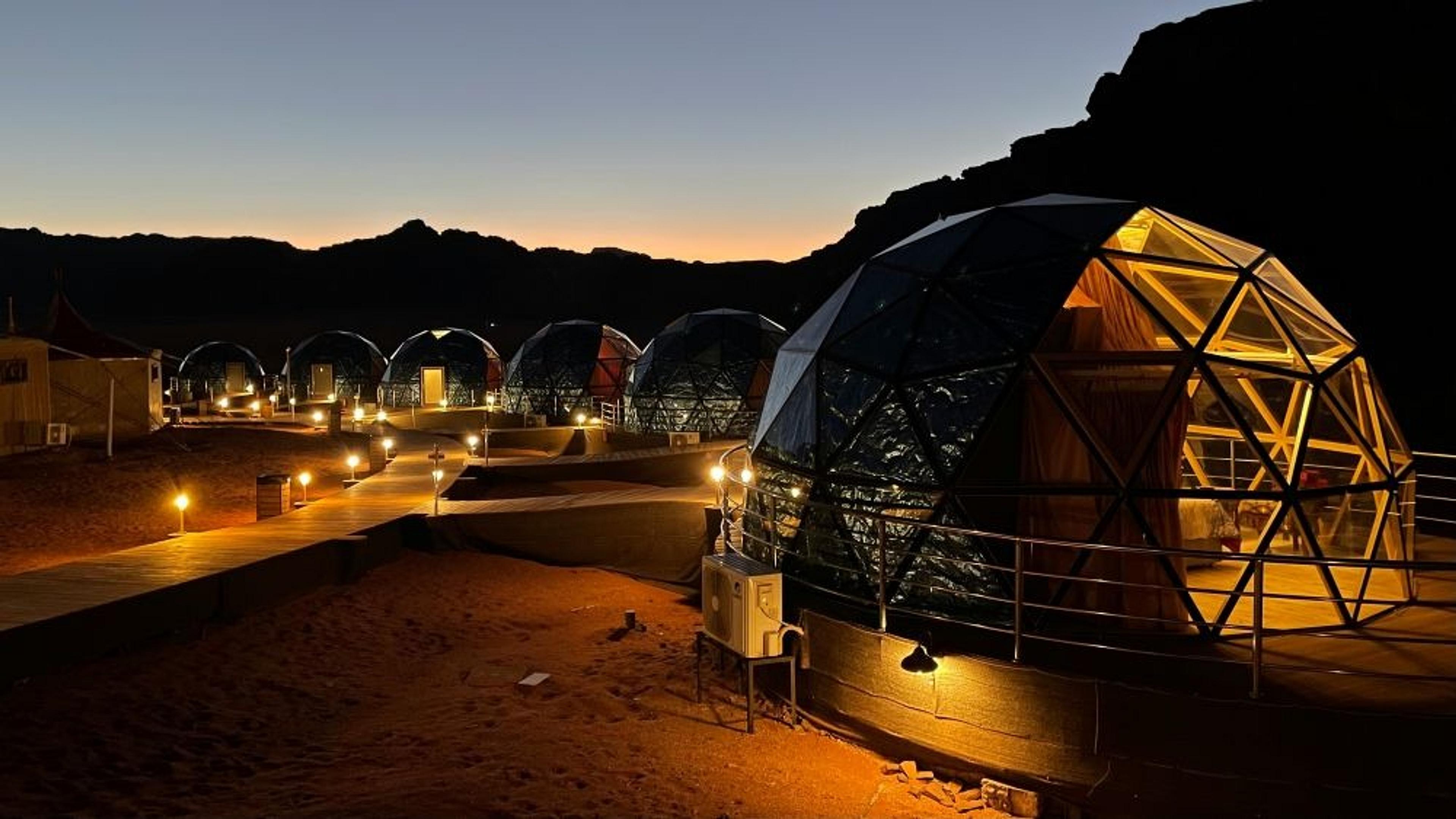 Geodesic domes illuminated at dusk in Wadi Rum, Jordan.