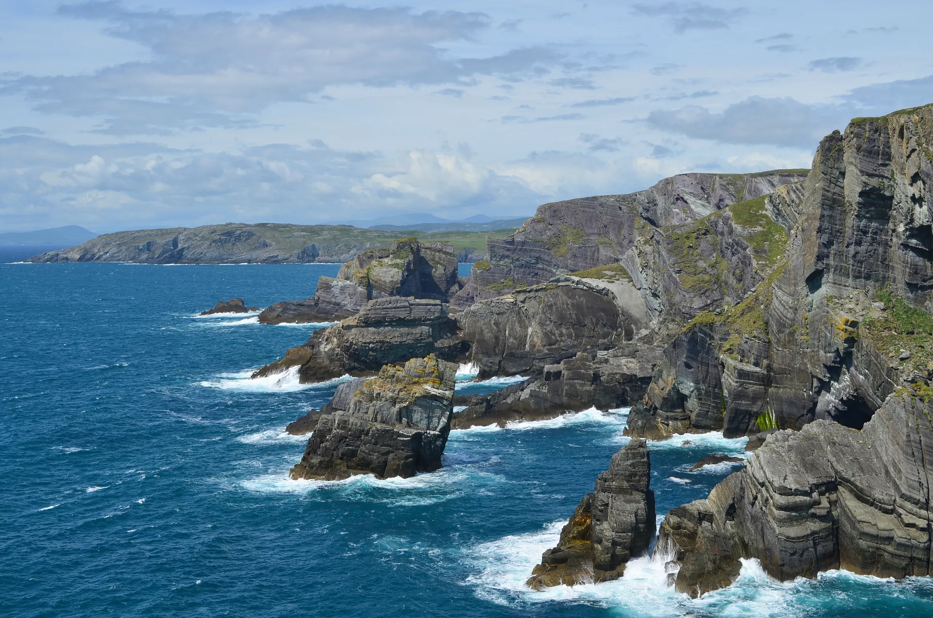 Rugged cliffs and rocky formations define the dramatic coastline of Mizen Head in County Cork, Ireland.
