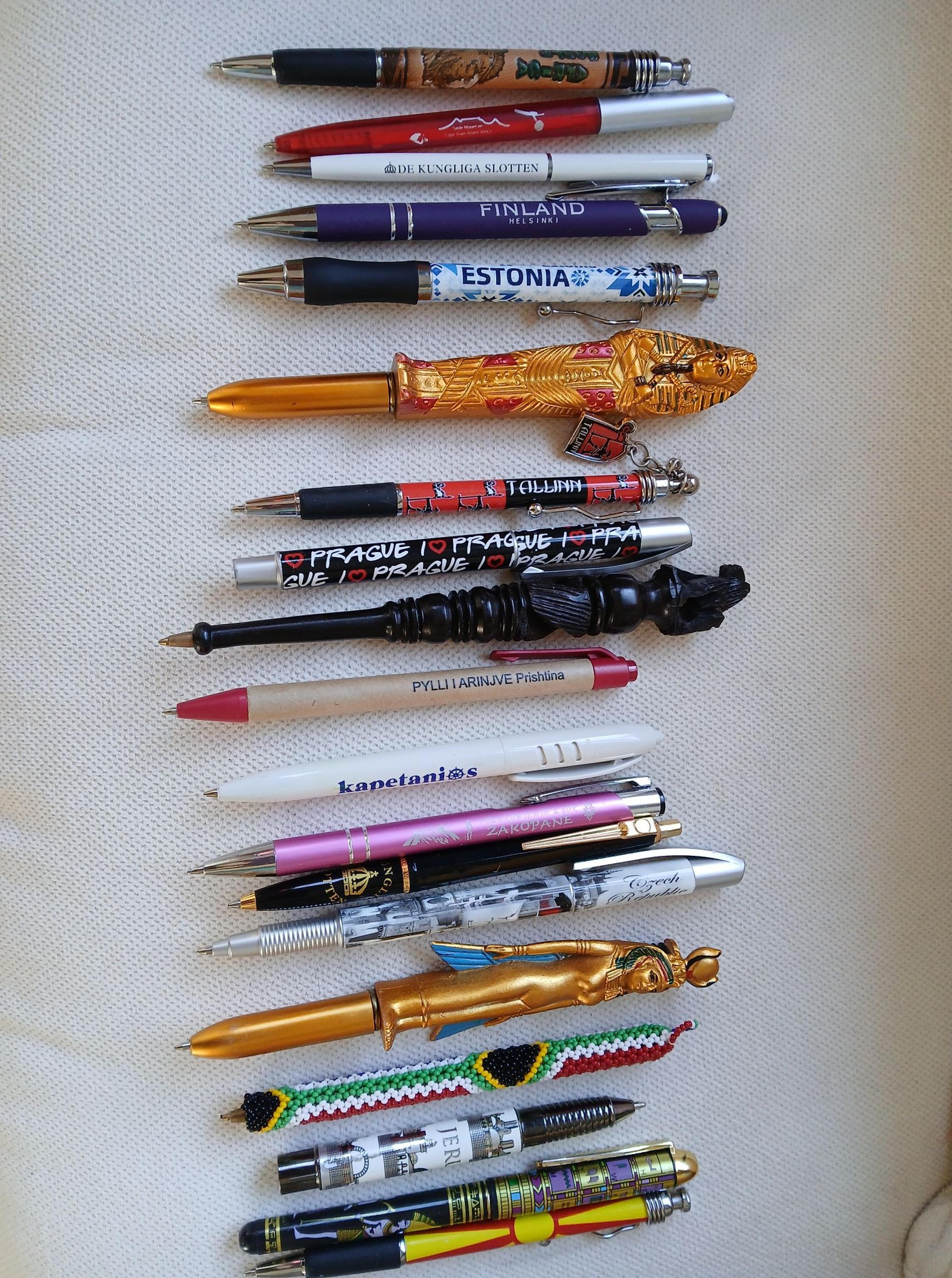A collection of souvenir pens from various locations such as Finland, Estonia, and Prague.