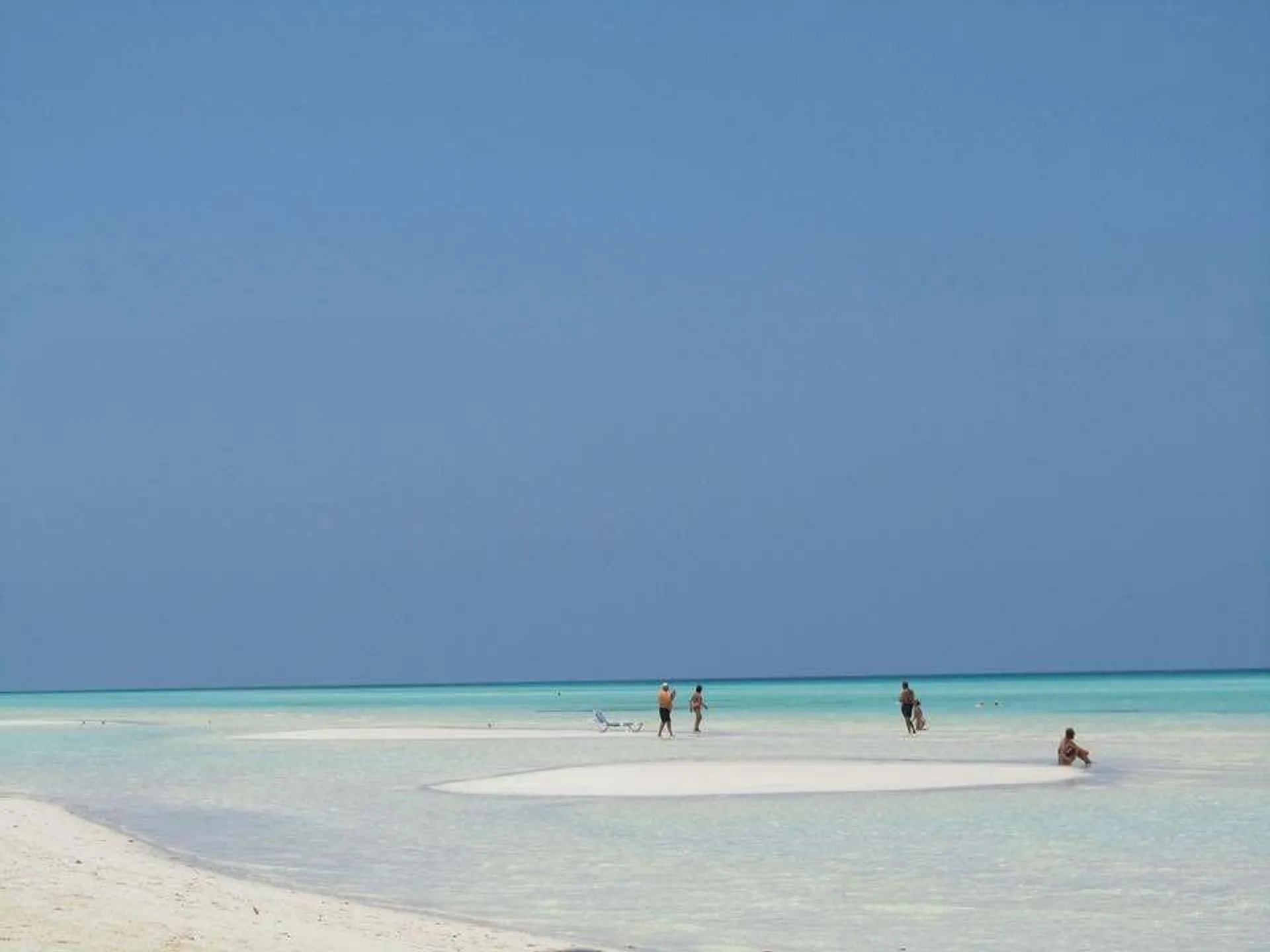 People enjoy the shallow turquoise waters and white sands of Cayo Guillermo in Cuba.