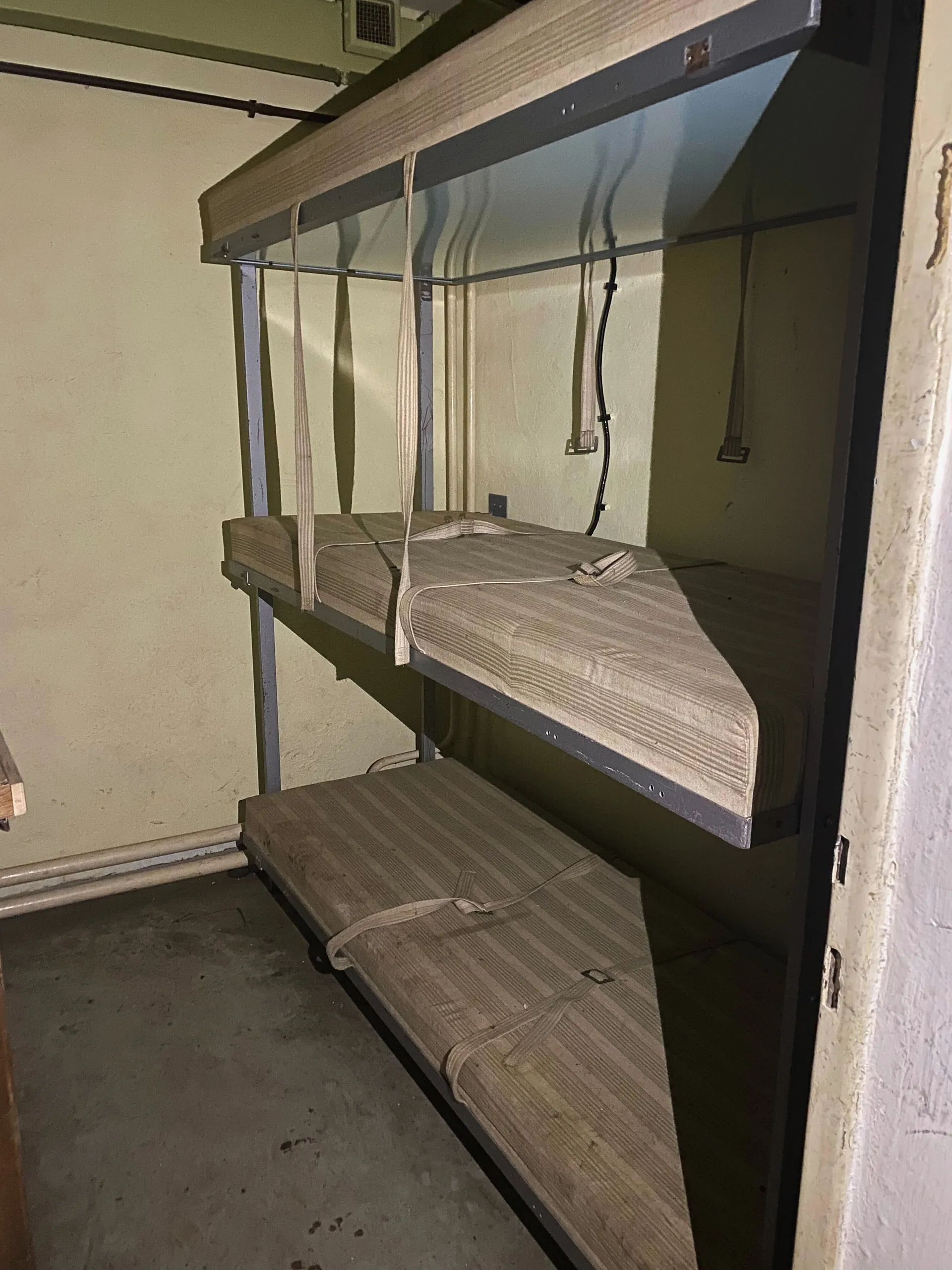 Bunkbeds stacked three high in a claustrophobic room