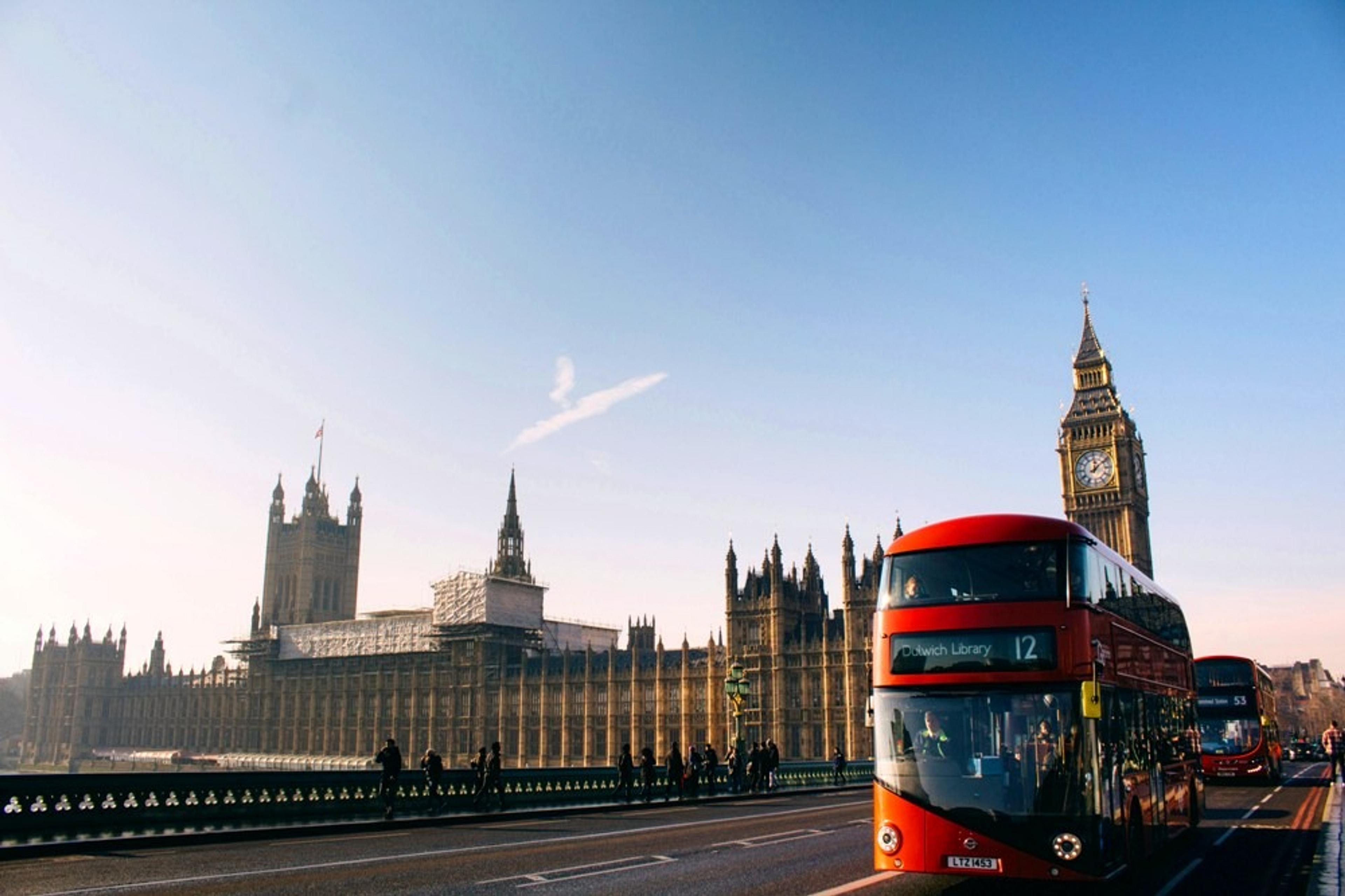 Red double decker bus in front of Houses of Parliament