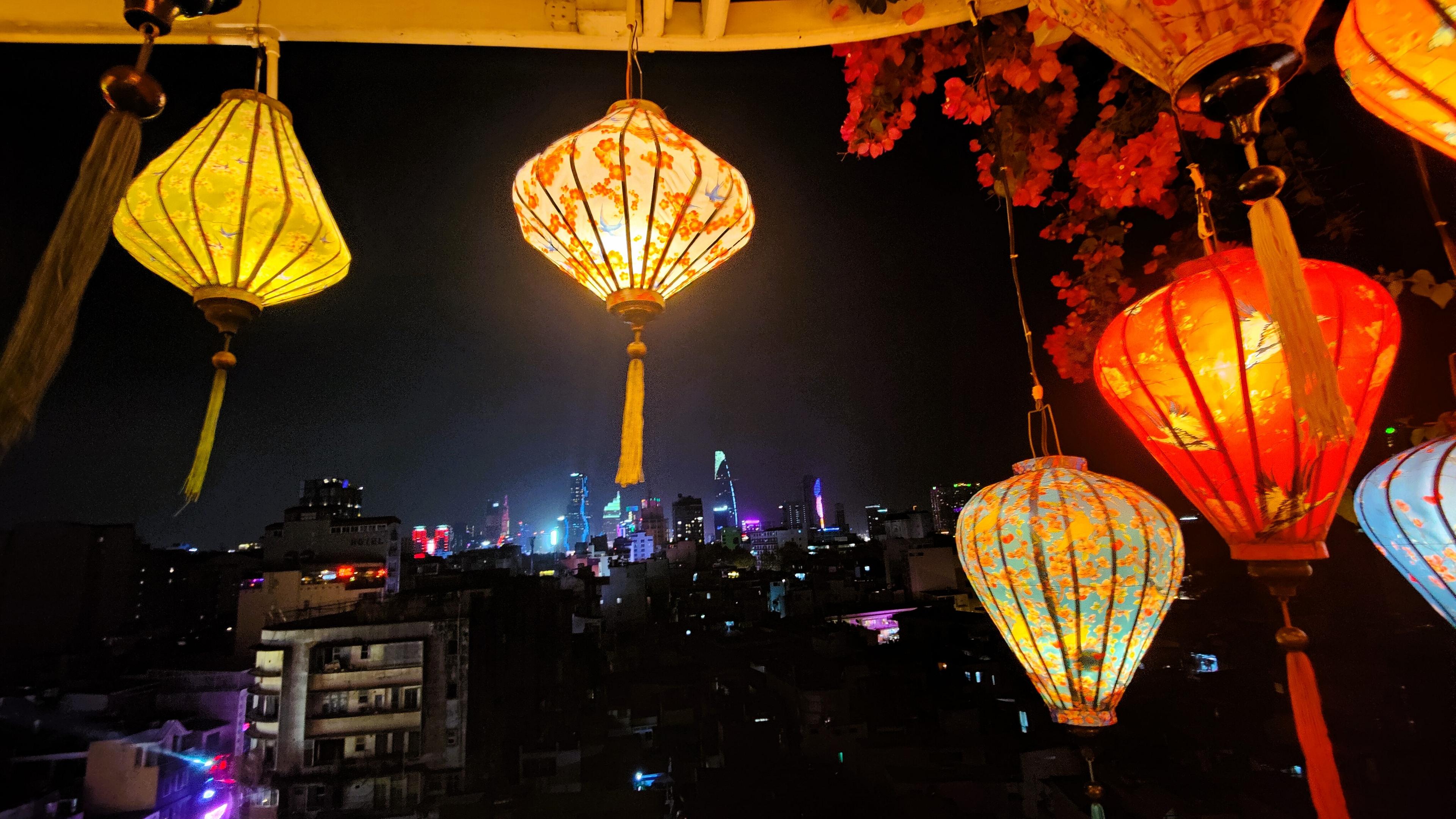 Ho Chi Minh City skyline at night with lanterns hanging in the foreground