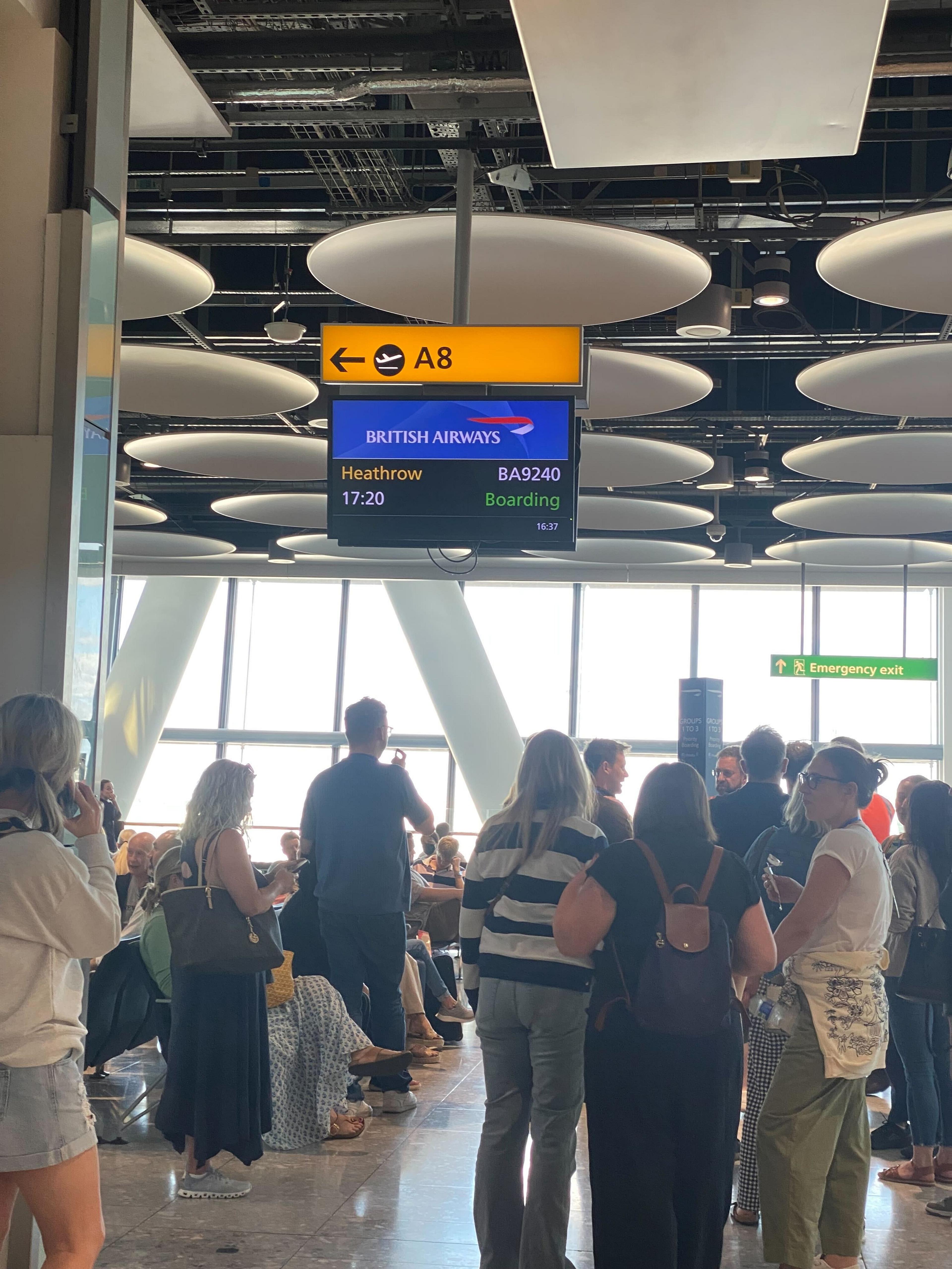 Passengers gather at gate A8 in Heathrow Airport as a British Airways flight to Heathrow is boarding.
