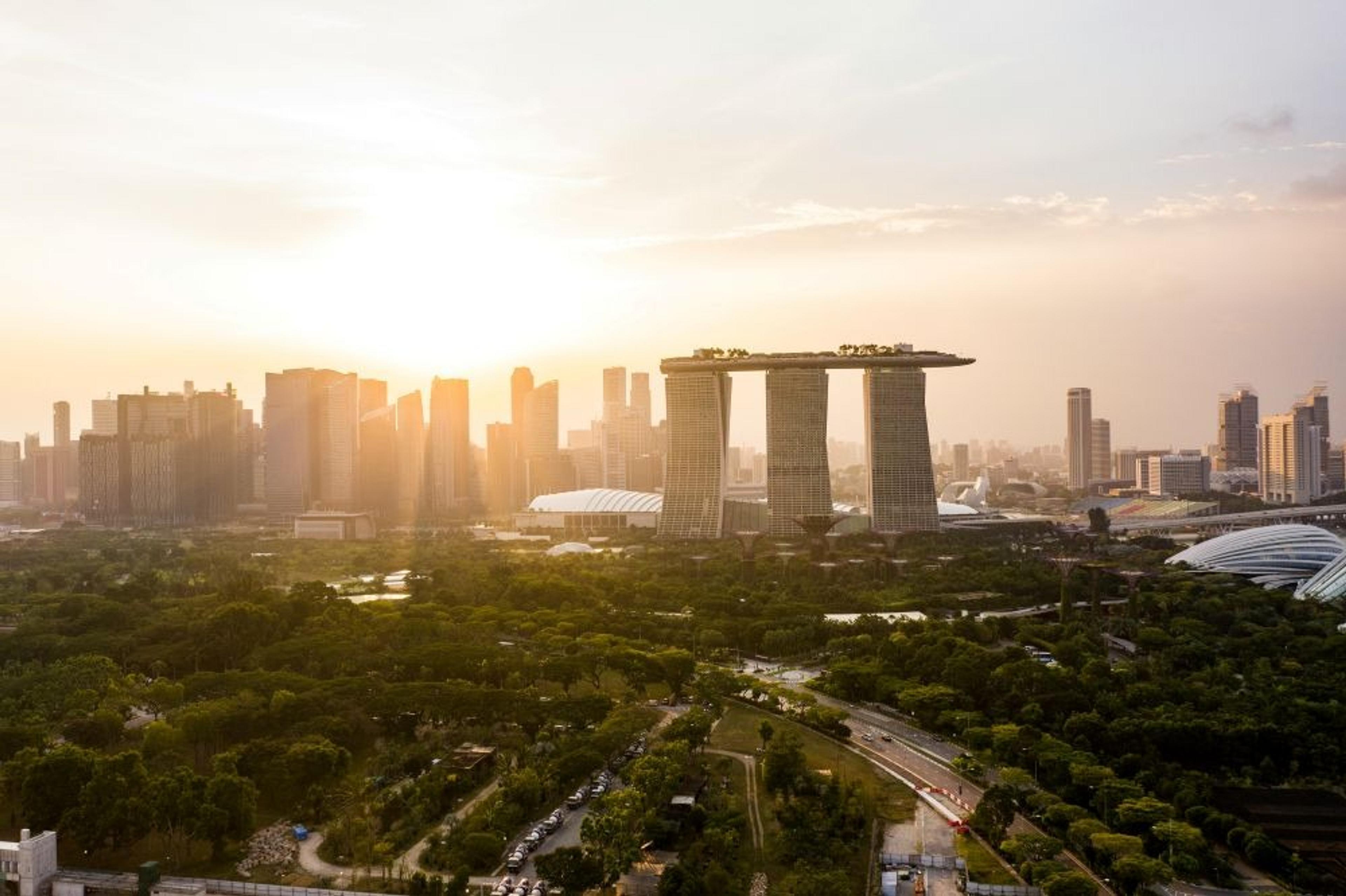 Aerial view of Marina Bay Sands and the surrounding skyline in Singapore during sunset.